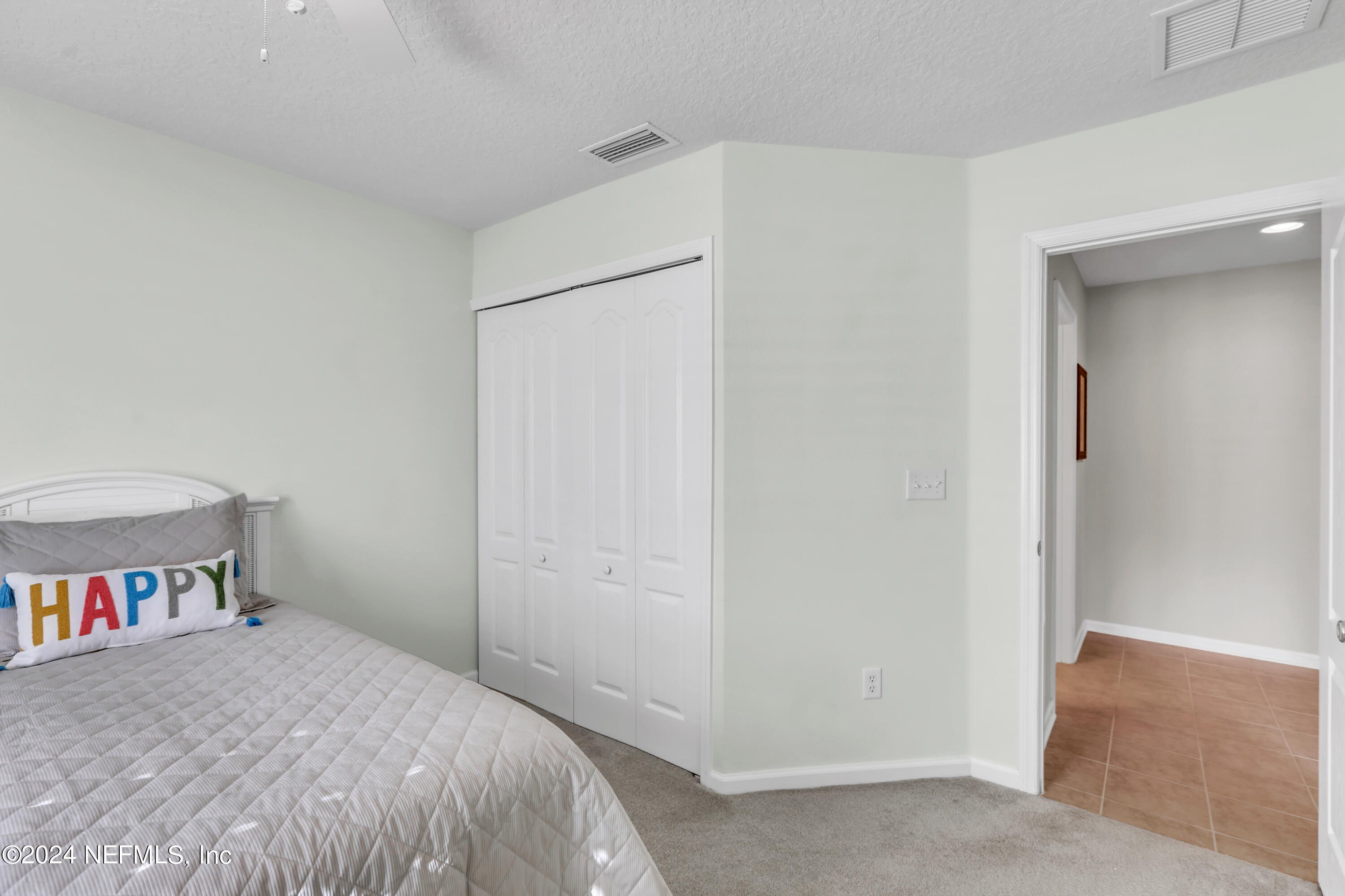 1184 Nochaway Drive St. Augustine, FL 32092 - Photo 20 of 39 a bed room with a bed and a book shelf