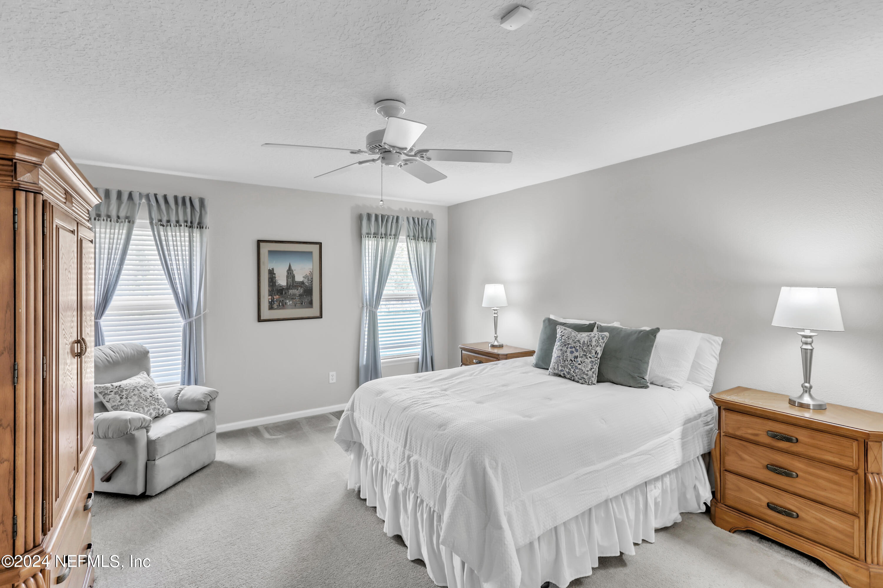 1184 Nochaway Drive St. Augustine, FL 32092 - Photo 6 of 39 a bedroom with a bed and a chandelier