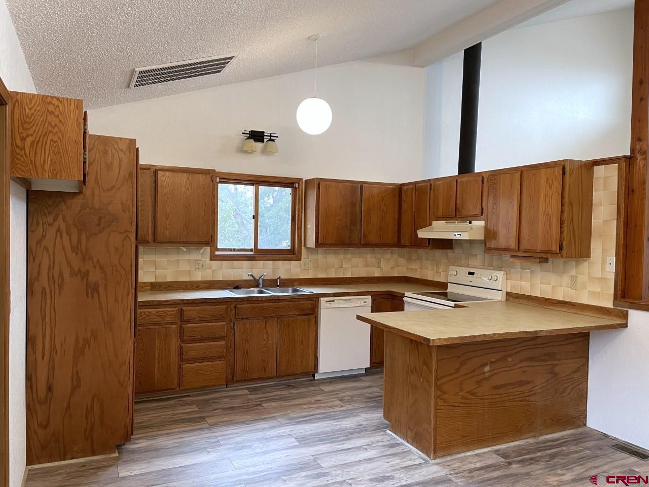 21566 Uintah Road Cedaredge, CO 81413 - Photo 12 of 33 a kitchen with stainless steel appliances granite countertop a sink stove and refrigerator