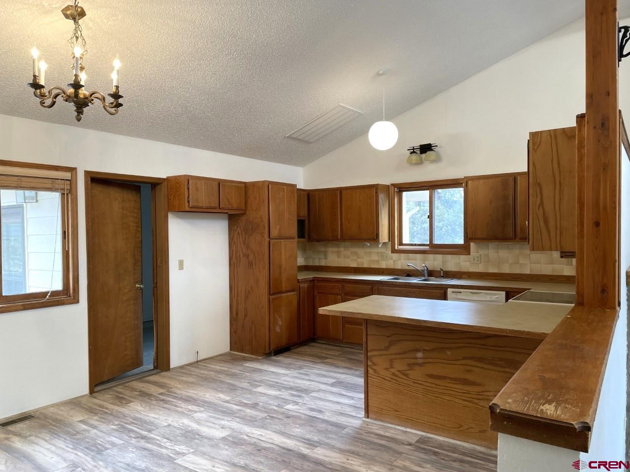 21566 Uintah Road Cedaredge, CO 81413 - Photo 13 of 33 a large kitchen with kitchen island a sink stainless steel appliances and cabinets
