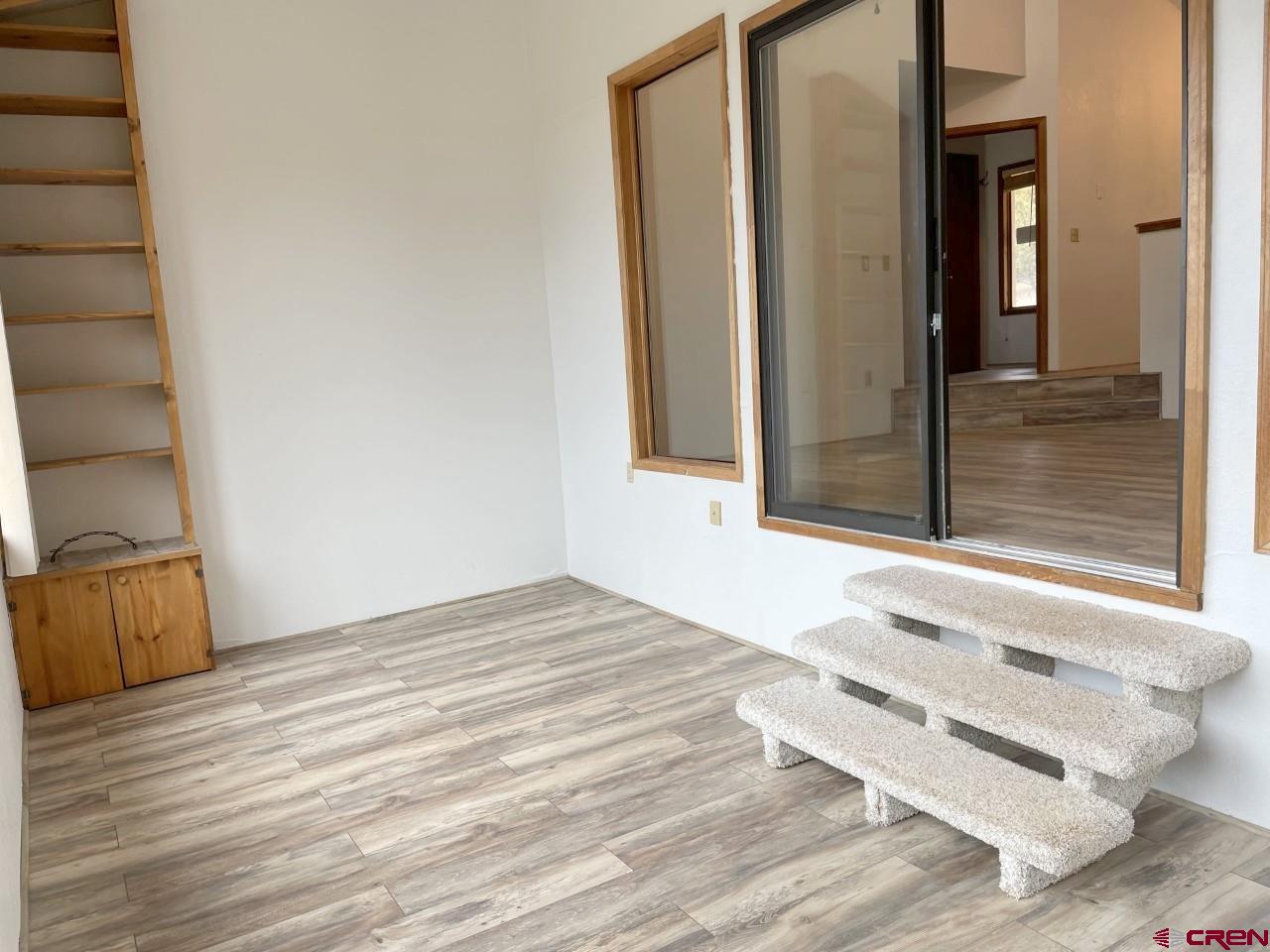 21566 Uintah Road Cedaredge, CO 81413 - Photo 7 of 33 a view of a room with wooden floor and cabinet