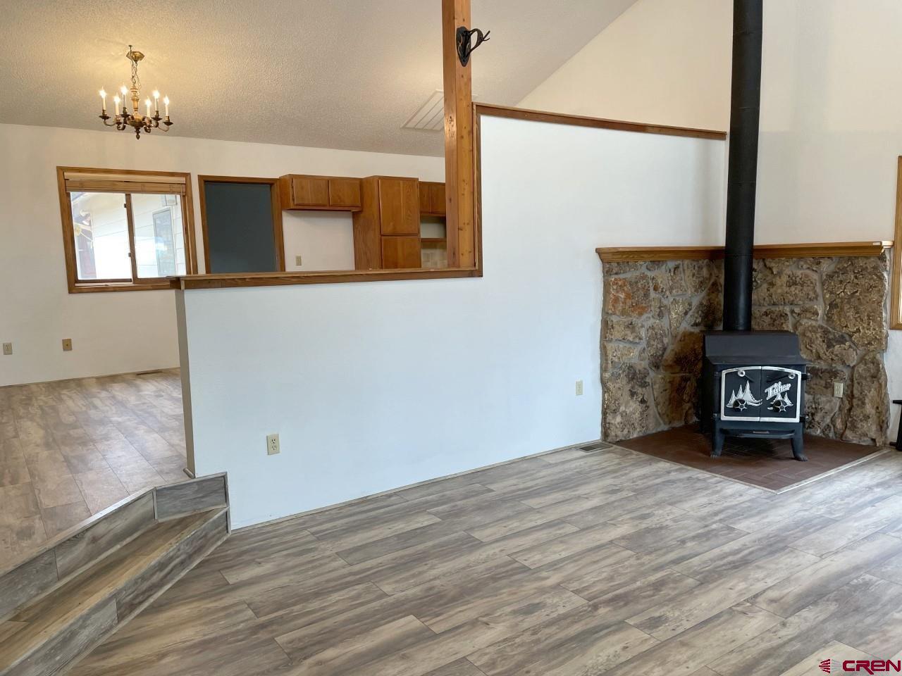 21566 Uintah Road Cedaredge, CO 81413 - Photo 9 of 33 a view of an empty room with wooden floor and a window