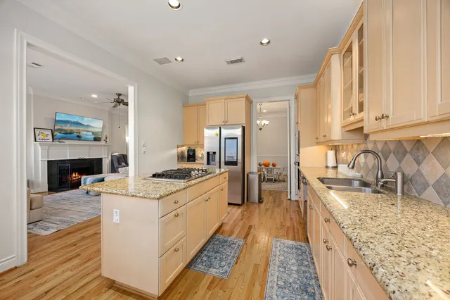 a large kitchen with stainless steel appliances granite countertop a stove and a sink