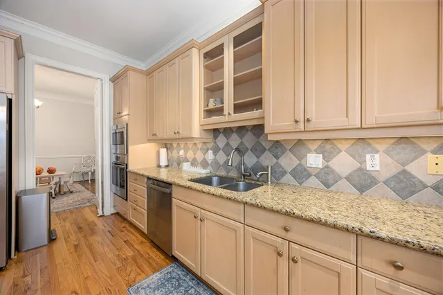 a kitchen with stainless steel appliances granite countertop a sink and cabinets