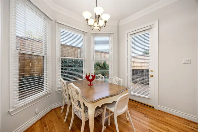 a view of a dining room with furniture wooden floor and chandelier
