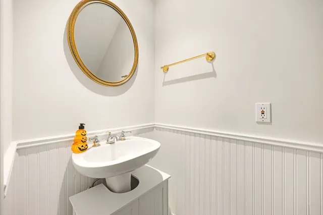 a bathroom with a sink a mirror and a toilet