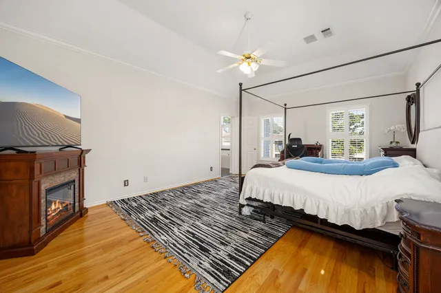 a spacious bedroom with a bed and a fireplace