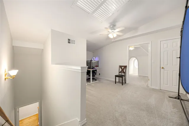 a view of game room with windows and ceiling fan
