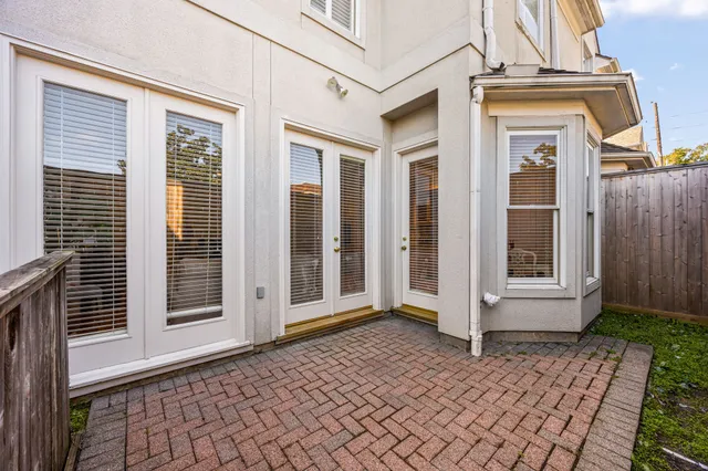 a view of a brick house with many windows