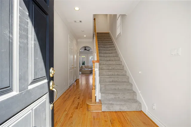 a view of entryway and hall with wooden floor