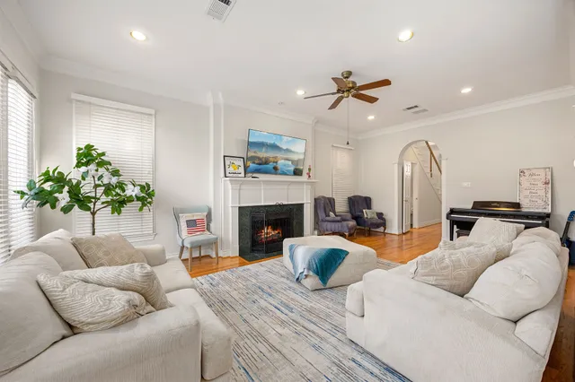 a living room with furniture fireplace and chandelier