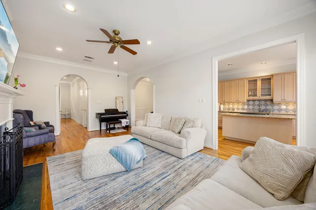 a living room with furniture and kitchen view