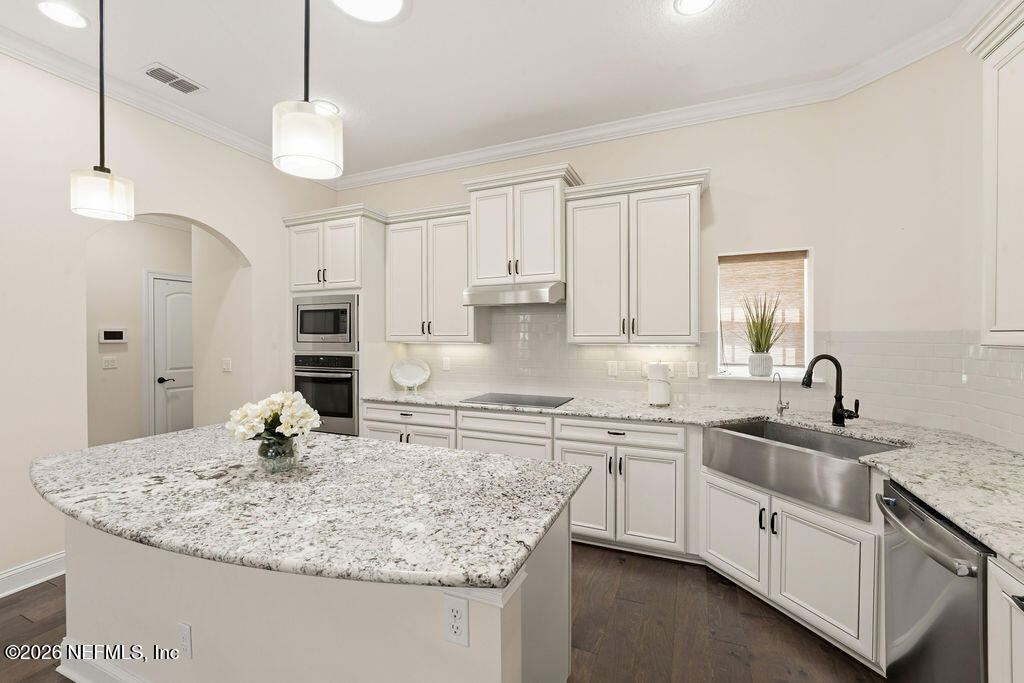 48 Ocale Court St. Augustine, FL 32084 - Photo 11 of 59 a kitchen with kitchen island granite countertop a sink a center island and cabinets