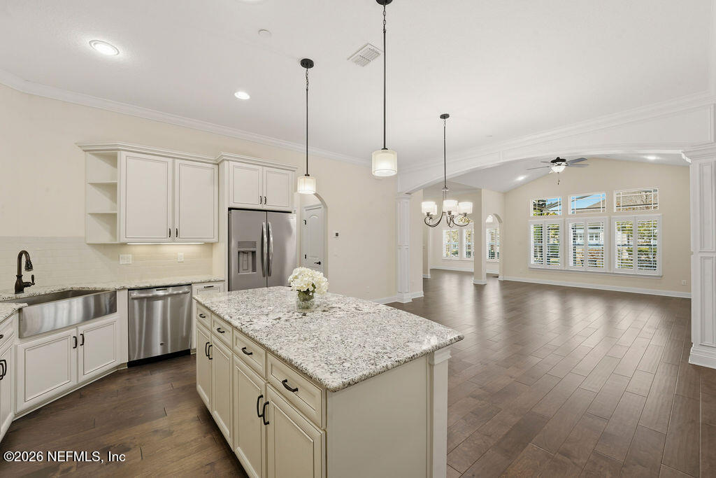 48 Ocale Court St. Augustine, FL 32084 - Photo 13 of 59 a kitchen with stainless steel appliances granite countertop a sink a oven a stove a refrigerator and white cabinets with wooden floor