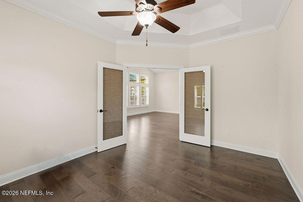 48 Ocale Court St. Augustine, FL 32084 - Photo 18 of 59 a view of an empty room with wooden floor and a ceiling fan