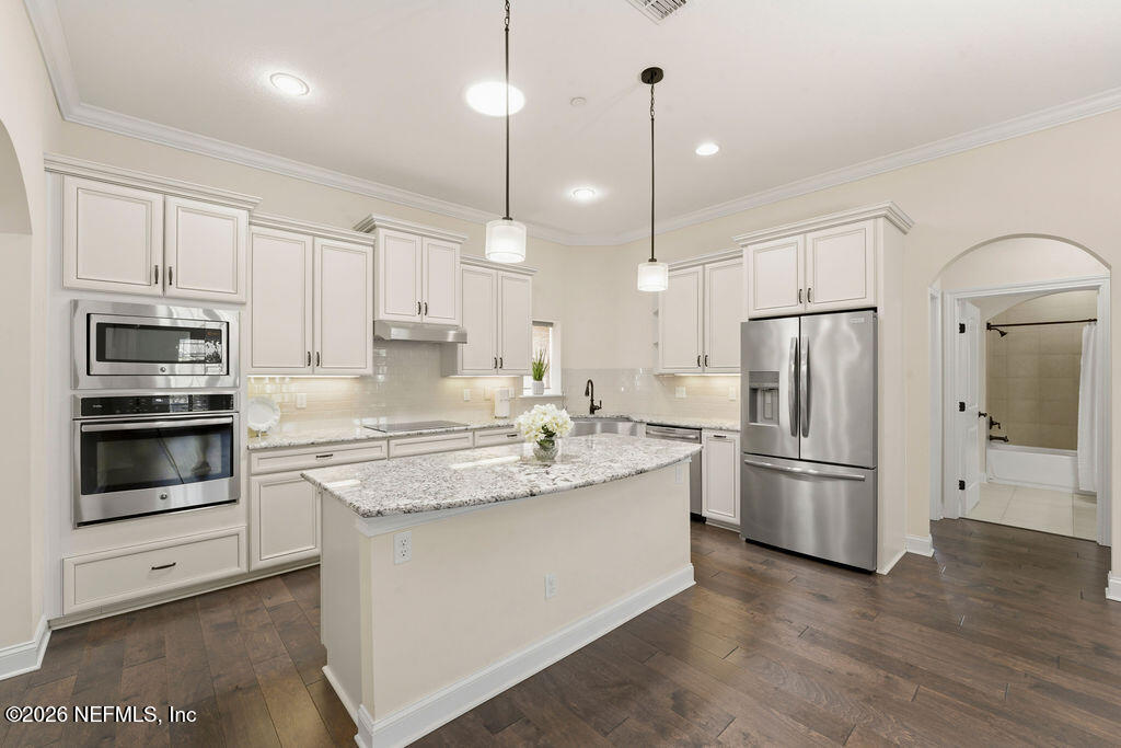 48 Ocale Court St. Augustine, FL 32084 - Photo 9 of 59 a kitchen with stainless steel appliances granite countertop a refrigerator a stove a sink and a oven with wooden floor