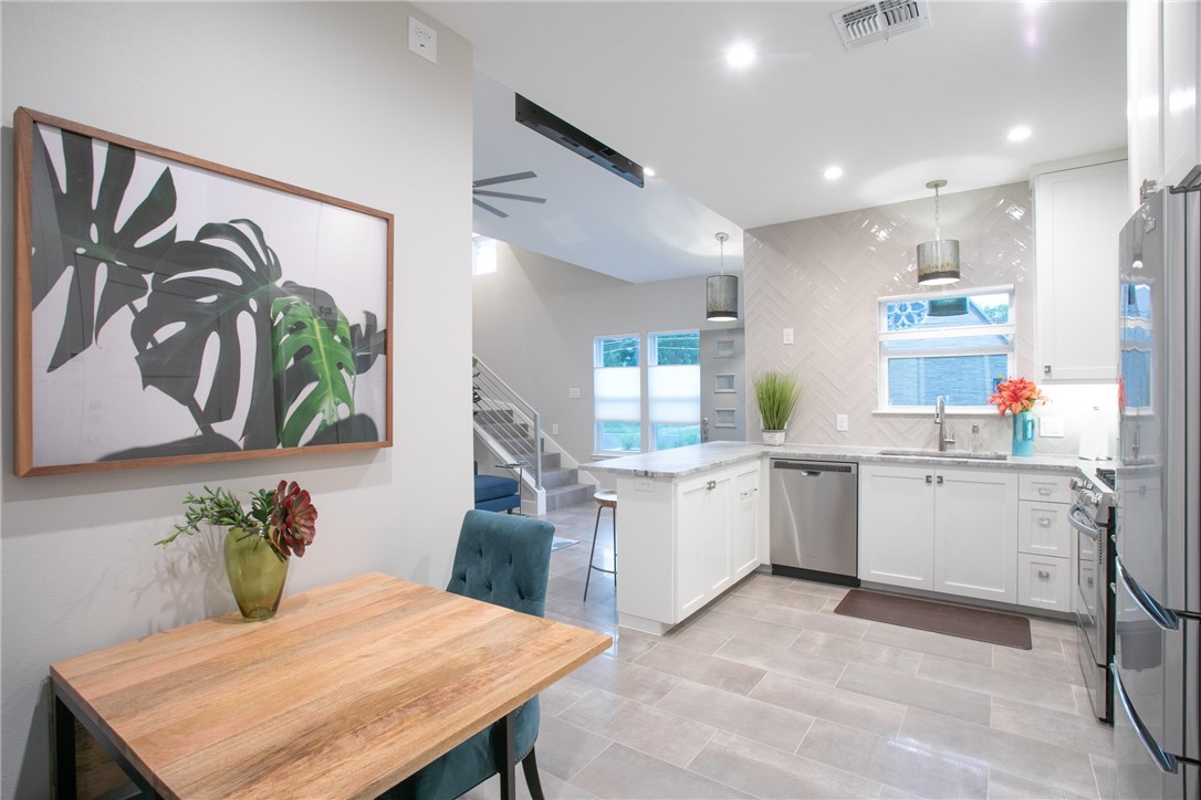 6613 Woodrow Avenue Austin, TX 78757 - Photo 11 of 27 a kitchen with a table chairs sink and cabinets