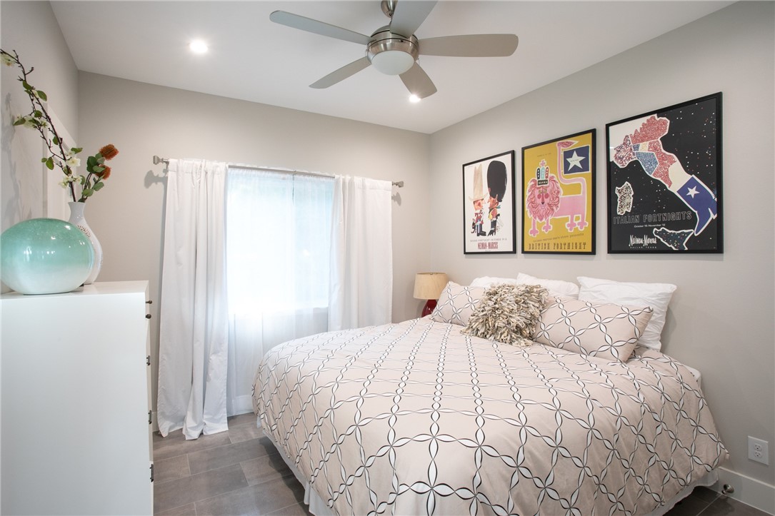 6613 Woodrow Avenue Austin, TX 78757 - Photo 15 of 27 a bedroom with a large bed and a painting on the wall