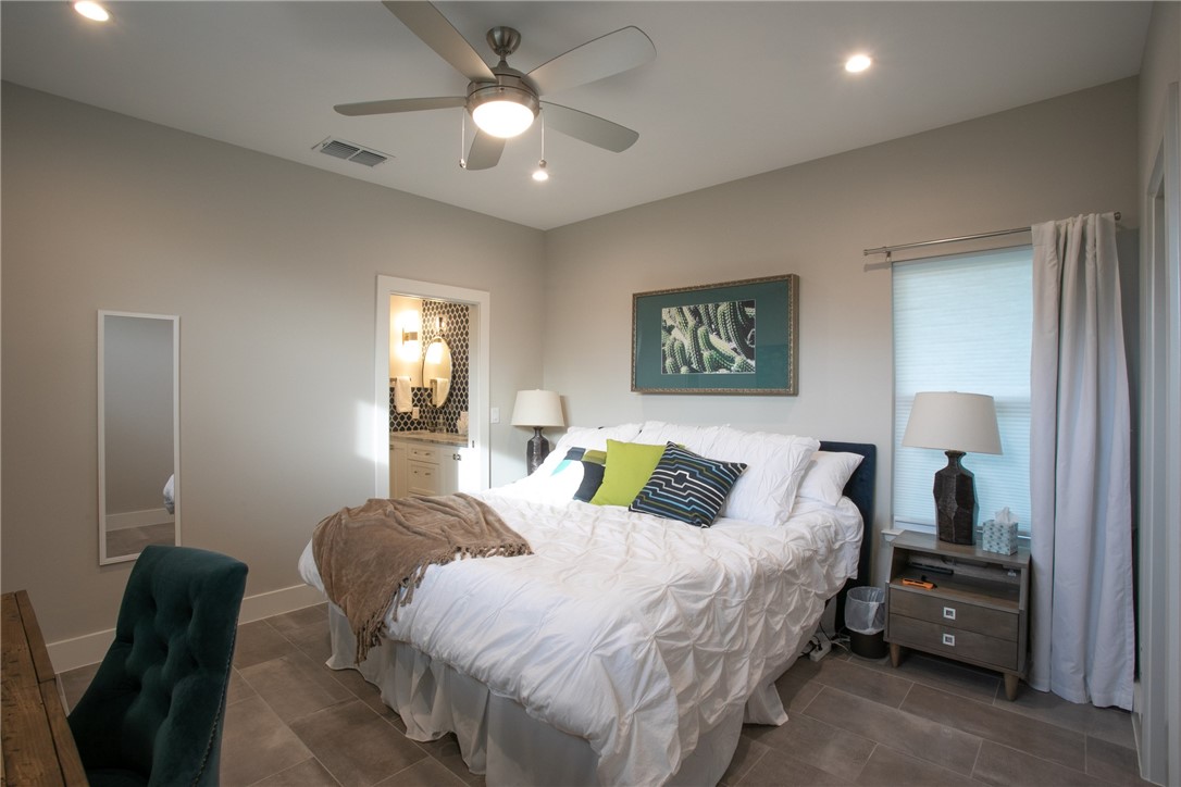 6613 Woodrow Avenue Austin, TX 78757 - Photo 17 of 27 a bedroom with a bed and a chandelier