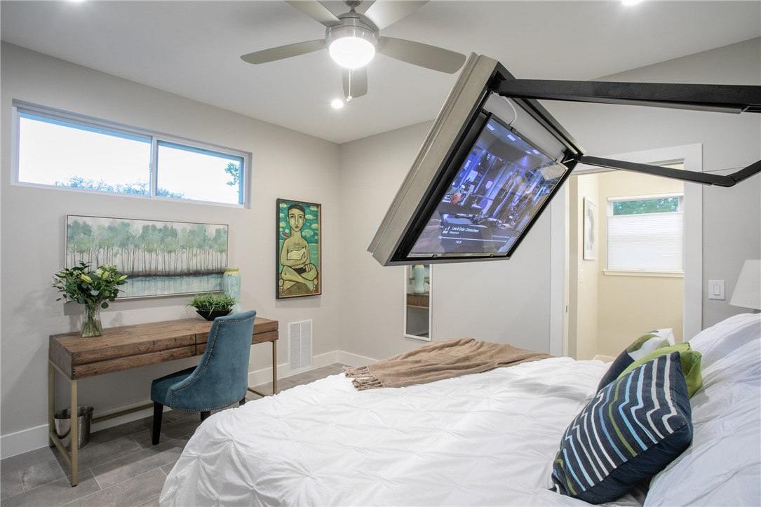 6613 Woodrow Avenue Austin, TX 78757 - Photo 18 of 27 a bedroom with a bed and a painting on the wall