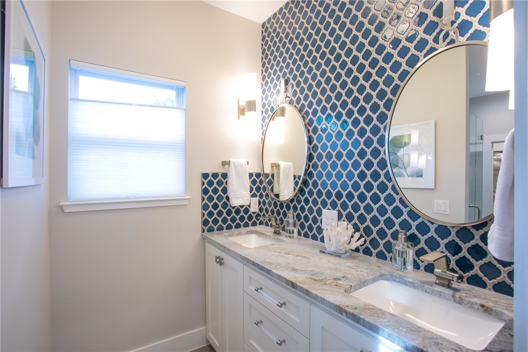6613 Woodrow Avenue Austin, TX 78757 - Photo 19 of 27 a bathroom with a sink mirror and double