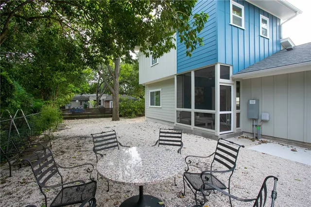 a view of a house with backyard and sitting area