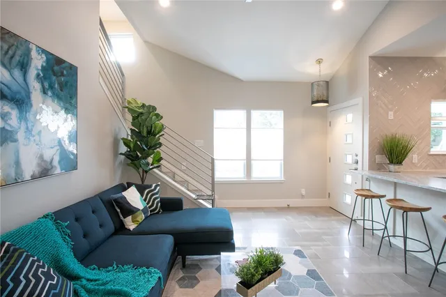 a living room with furniture and a large window