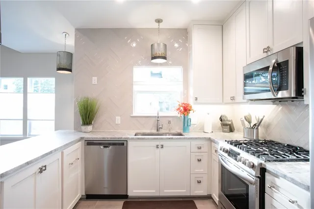 a kitchen with a table chairs sink and cabinets