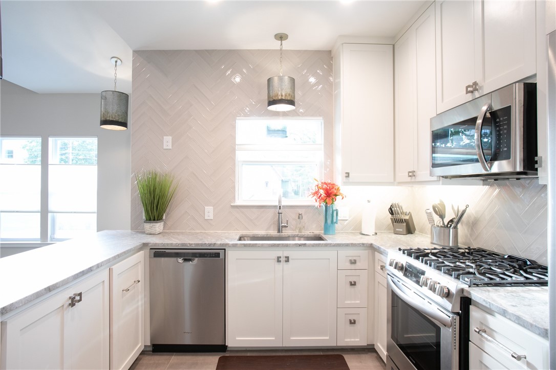 6613 Woodrow Avenue Austin, TX 78757 - Photo 10 of 27 a kitchen with granite countertop a sink stove and cabinets