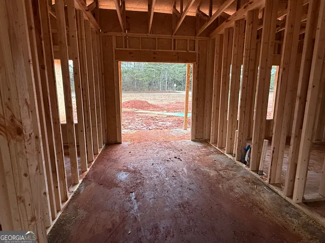 a view of an empty room with a window and a door