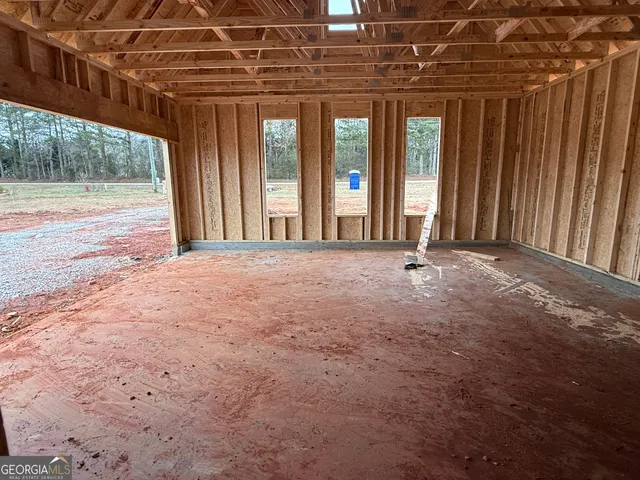 a view of a room with a wooden floor and a window