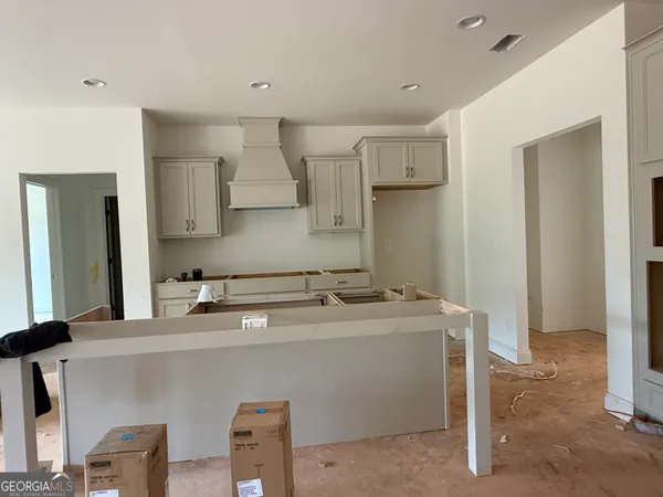 a view of an empty room with a fireplace and a window