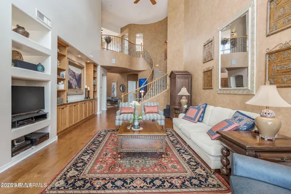 a living room with furniture fireplace and rug