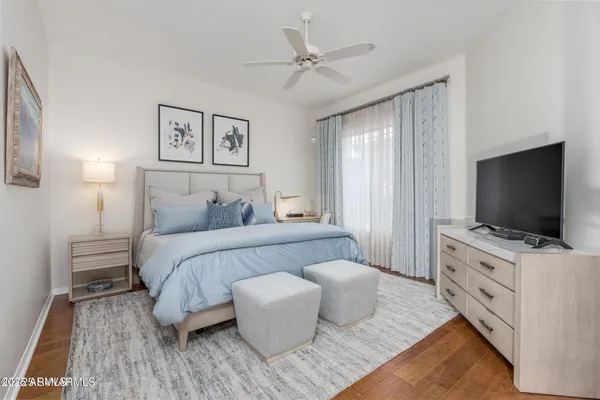 a bedroom with a bed and a painting on the wall