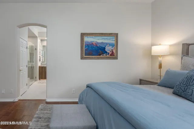 a bathroom with a granite countertop sink a mirror and a shower