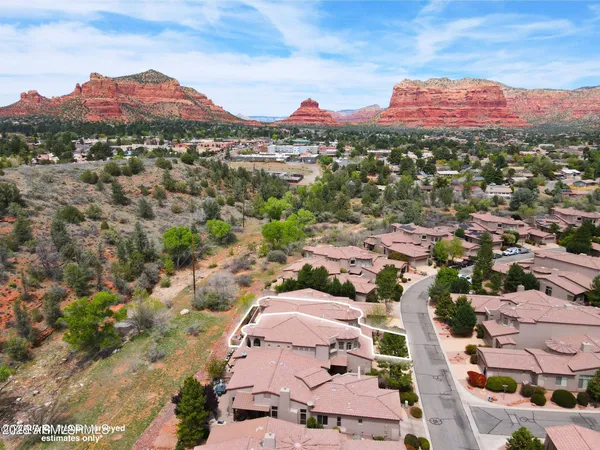 an aerial view of residential houses with outdoor space and street view