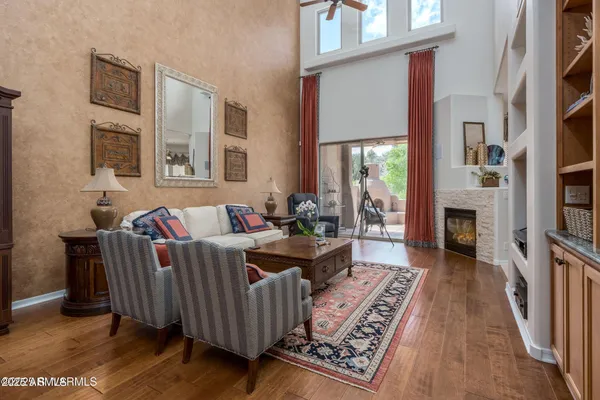 a living room with furniture flat screen tv and a fireplace
