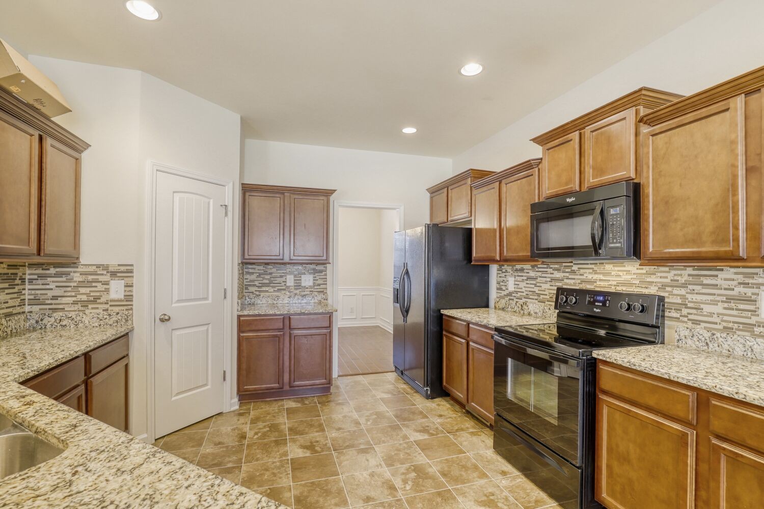 1011 Beverly Lane Spring Hill, TN 37174 - Photo 10 of 20 a kitchen with stainless steel appliances granite countertop a stove refrigerator and microwave