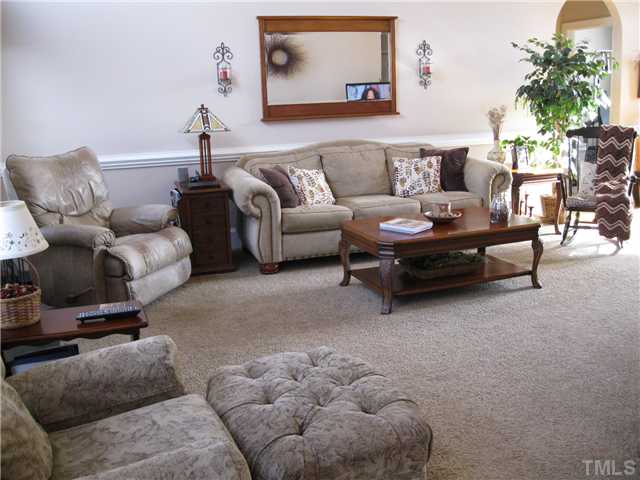 1109 Golden Grain Road Garner, NC 27529 - Photo 3 of 25 a living room with furniture and a potted plant