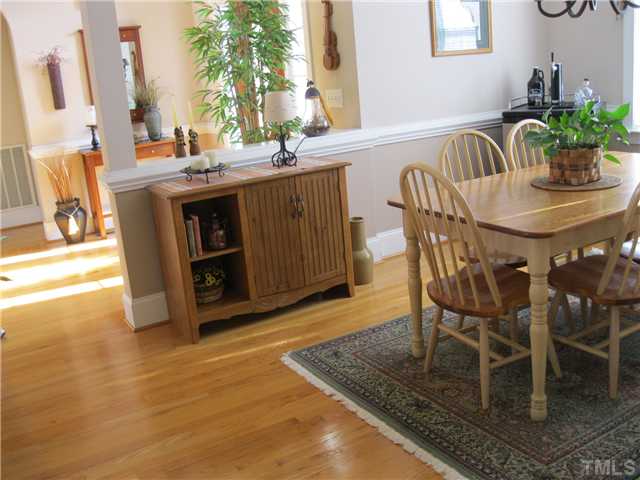 1109 Golden Grain Road Garner, NC 27529 - Photo 5 of 25 a view of a dining room with furniture and a potted plant