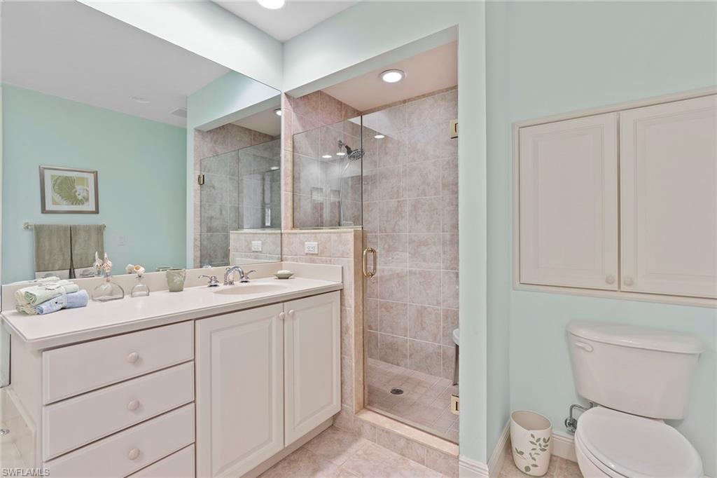7865 Hawthorne Drive, Unit 402 Naples, FL 34113 - Photo 19 of 33 a bathroom with a sink a toilet and shower