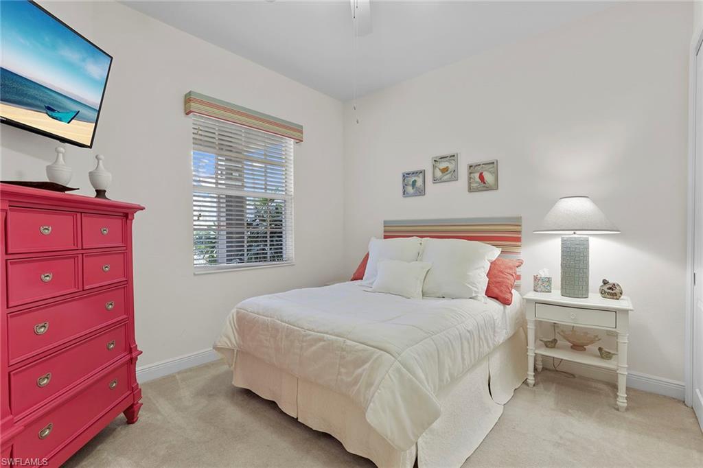 7865 Hawthorne Drive, Unit 402 Naples, FL 34113 - Photo 20 of 33 a bedroom with a bed and a window
