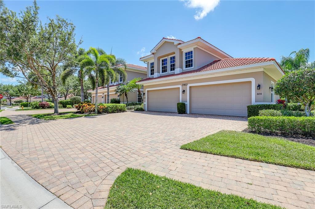 7865 Hawthorne Drive, Unit 402 Naples, FL 34113 - Photo 2 of 33 a front view of a house with a yard and potted plants
