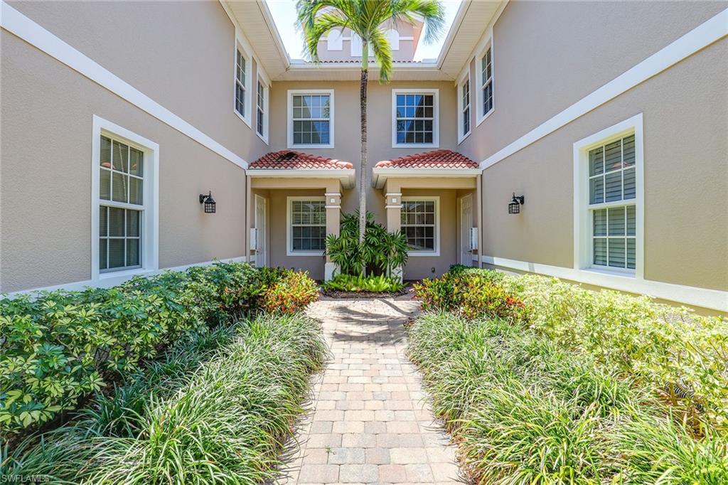 7865 Hawthorne Drive, Unit 402 Naples, FL 34113 - Photo 3 of 33 front view of a house with a yard