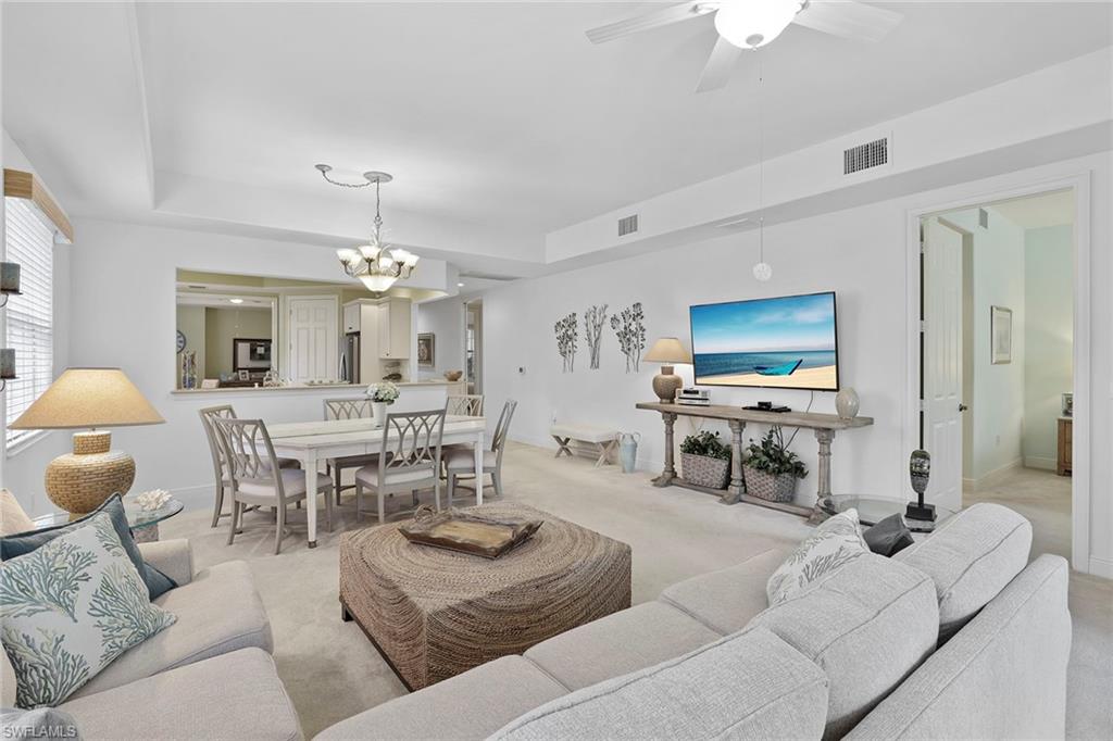 7865 Hawthorne Drive, Unit 402 Naples, FL 34113 - Photo 9 of 33 a living room with furniture and a flat screen tv