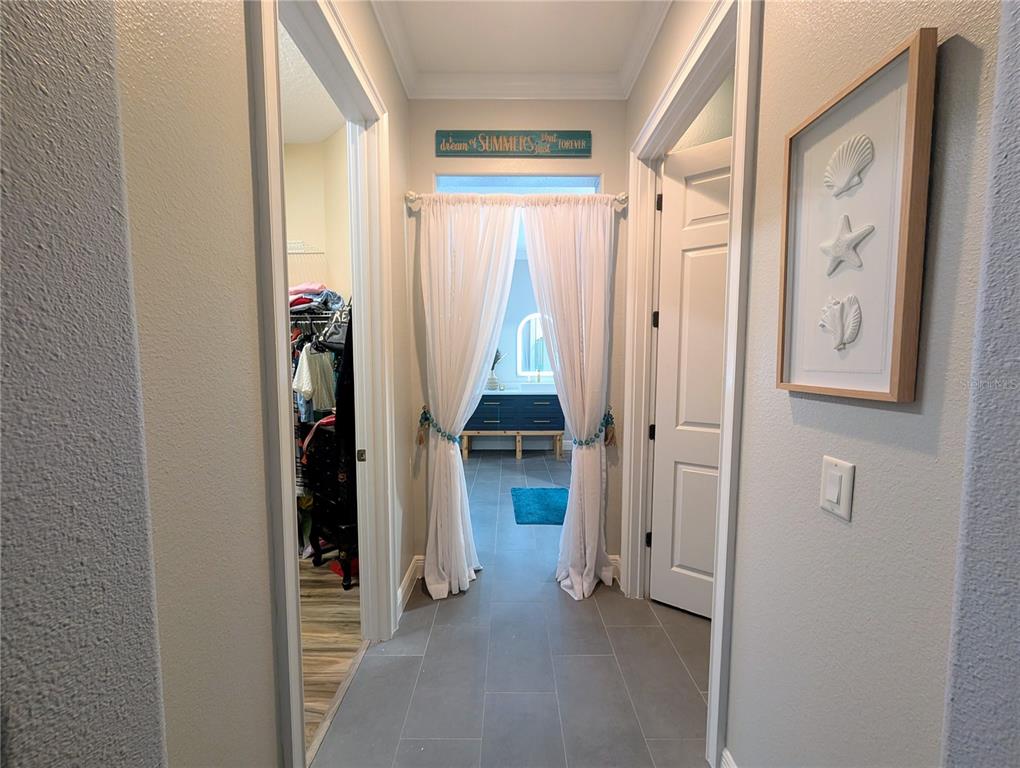 7429 Gathering Court Reunion, FL 34747 - Photo 16 of 40 a view of a hallway with wooden shelves