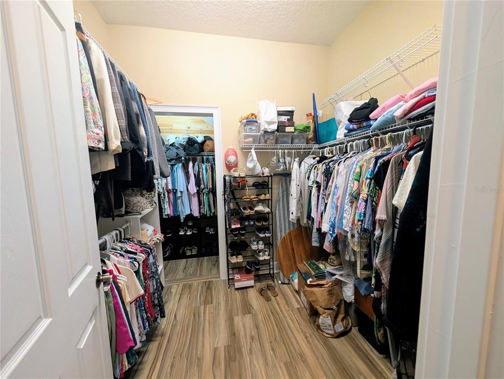 7429 Gathering Court Reunion, FL 34747 - Photo 17 of 40 a view of walk in closet with clothes and shoes