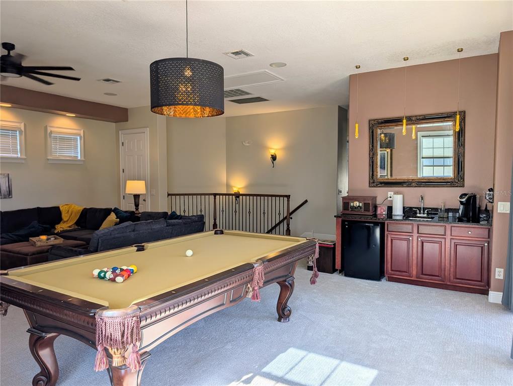 7429 Gathering Court Reunion, FL 34747 - Photo 24 of 40 a living room with a table and chairs