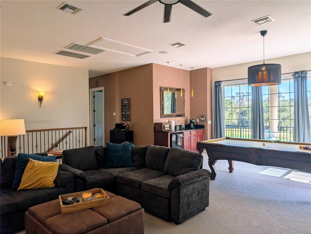 7429 Gathering Court Reunion, FL 34747 - Photo 26 of 40 a living room with furniture and a window