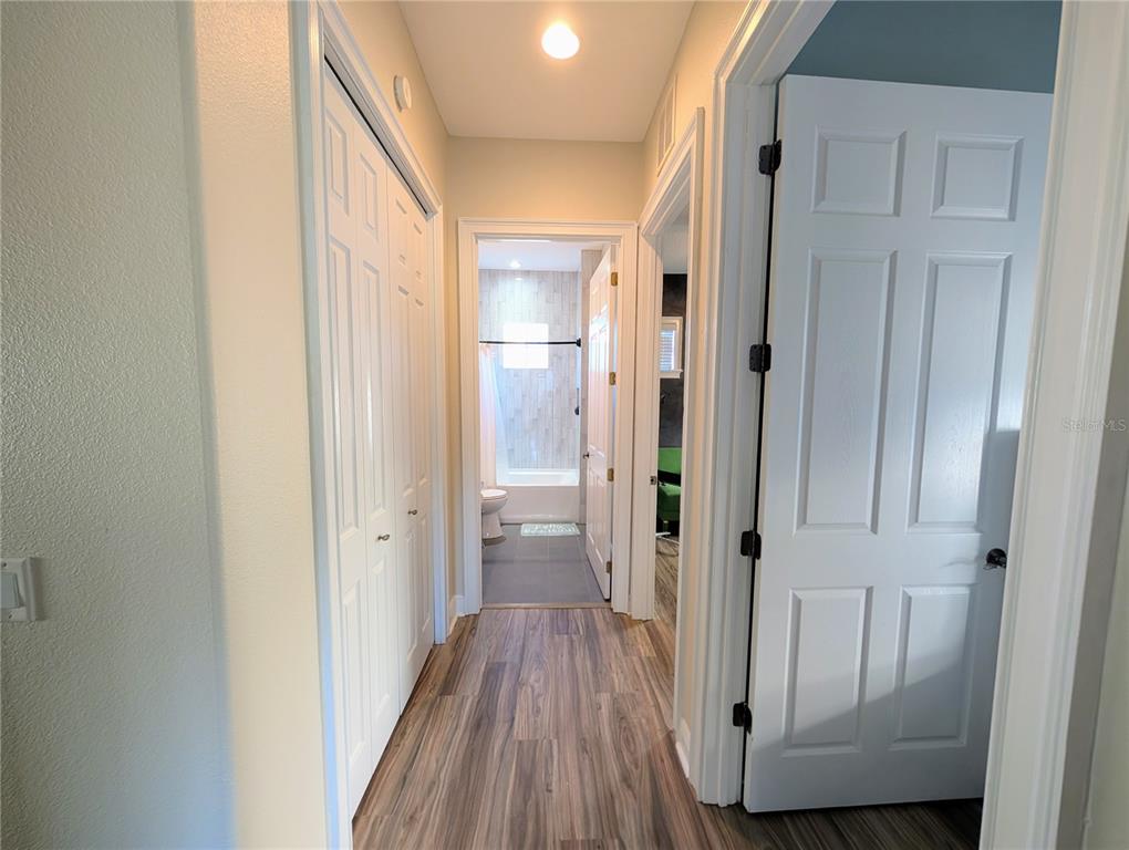 7429 Gathering Court Reunion, FL 34747 - Photo 27 of 40 a view of a hallway with wooden floor and a bathroom